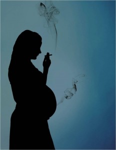 Silhouette of pregnant woman smoking