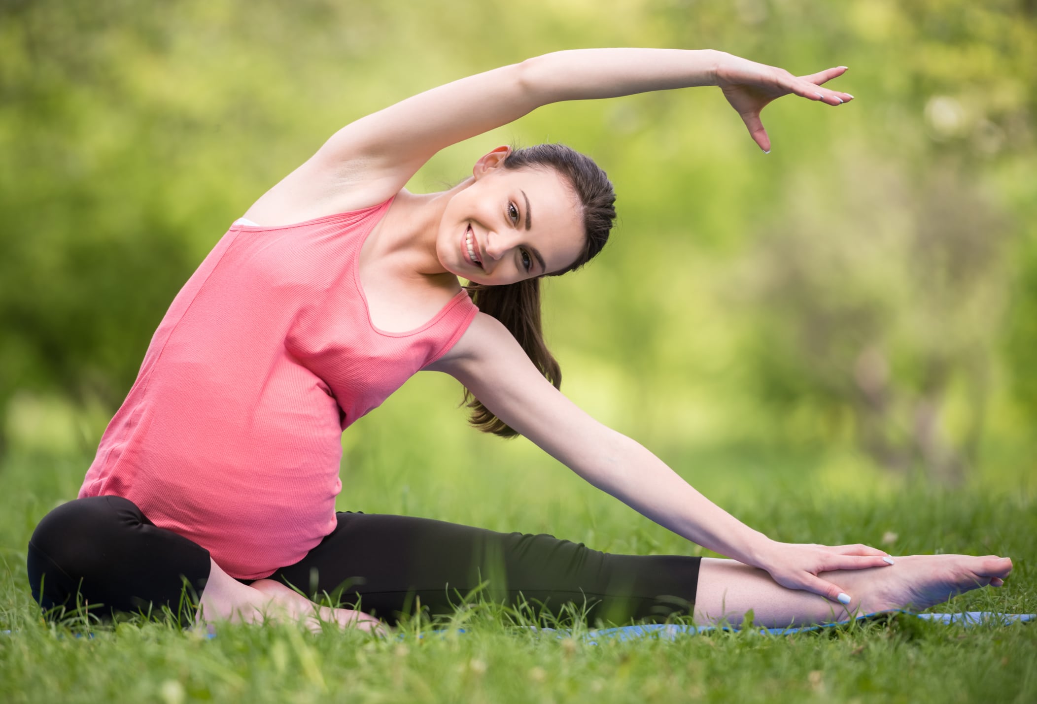 Image of woman doing yoga while pregnant