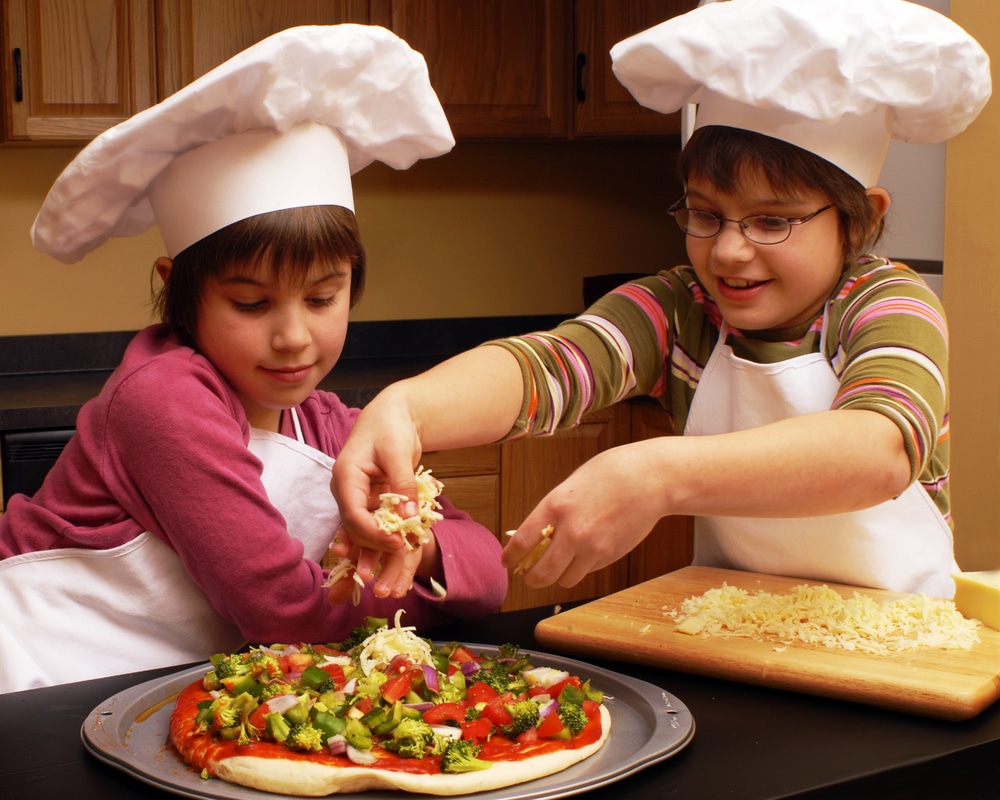 Picture of two children making pizza