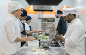 People preparing food in a commercial kitchen