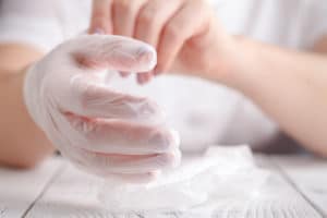 Image of a person removing latex gloves