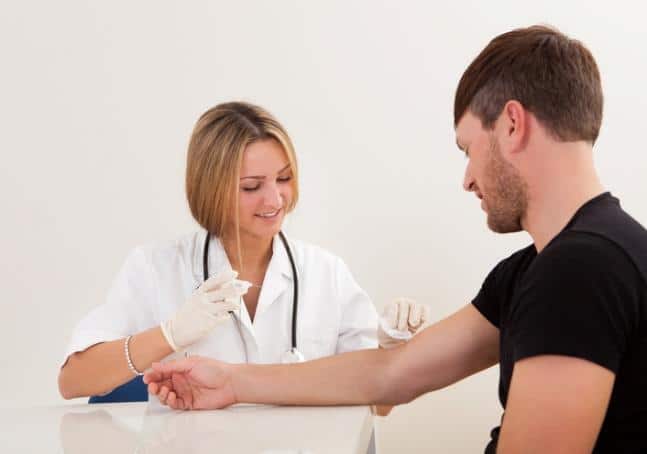 Nurse giving young male a needle