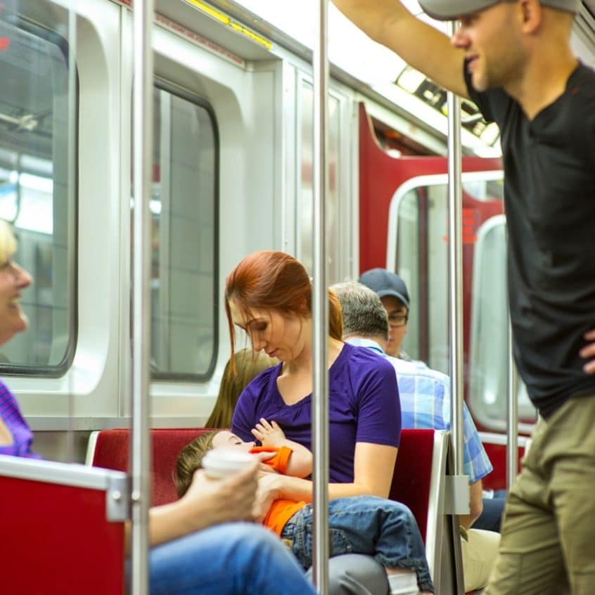 Woman breastfeeding on subway