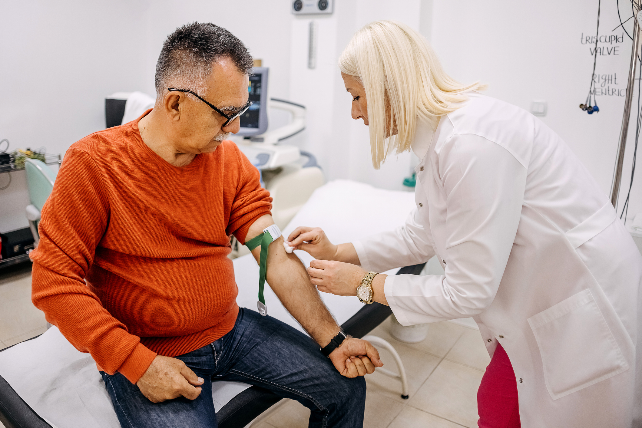Nurse doing procedure of a blood capture from a vein.